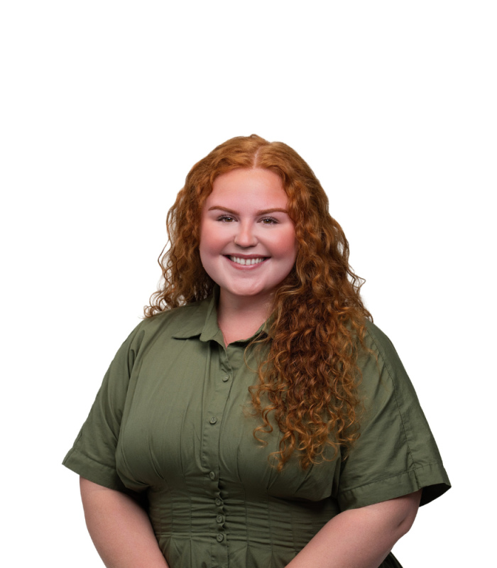 Meet Our Team - Professional and Welcoming Group at a Conference Table Faces the Camera, Team Leader Sitting on the Table with Arms Folded